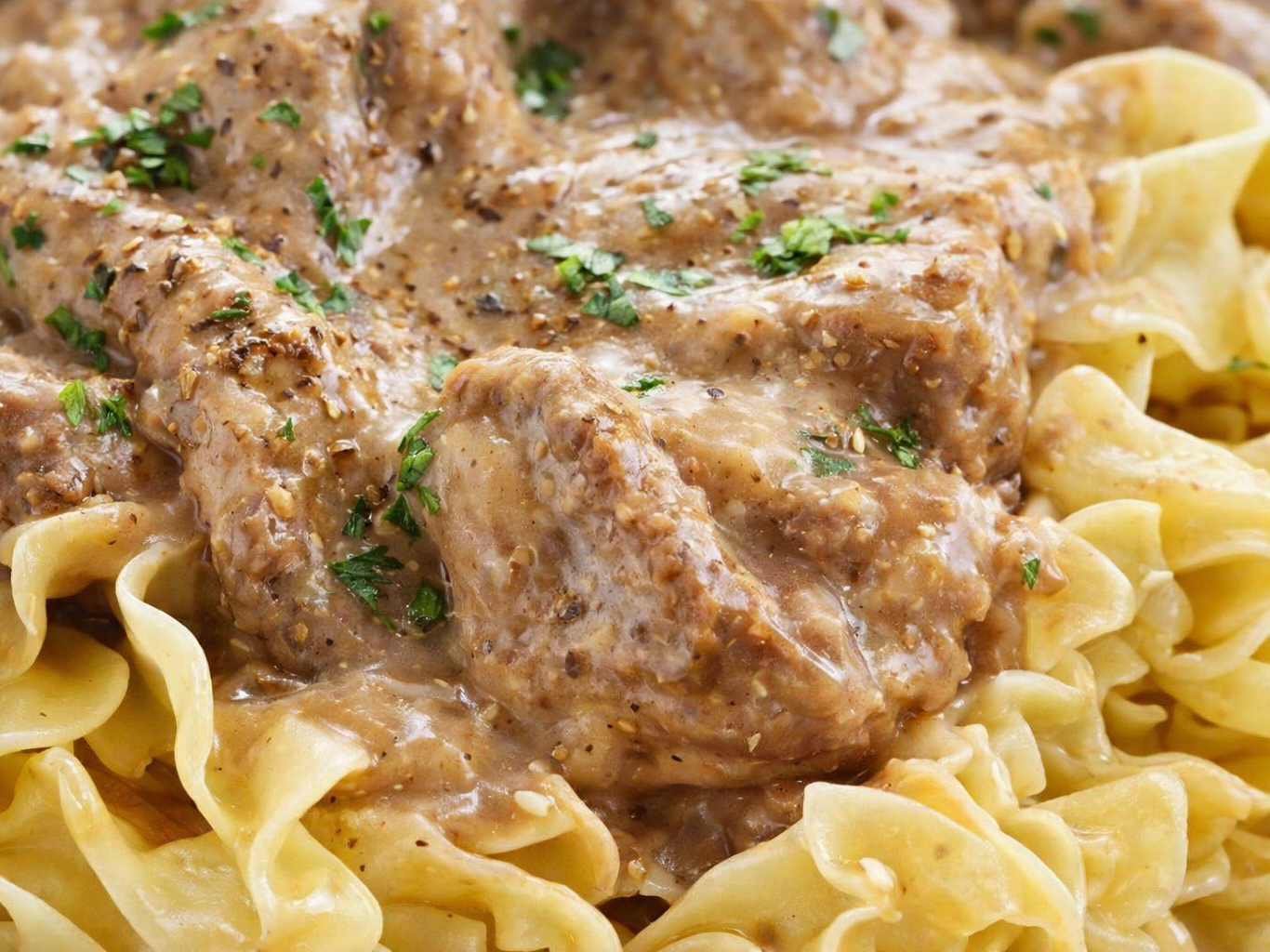 Beef stroganoff over egg noodles, topped with parsley
