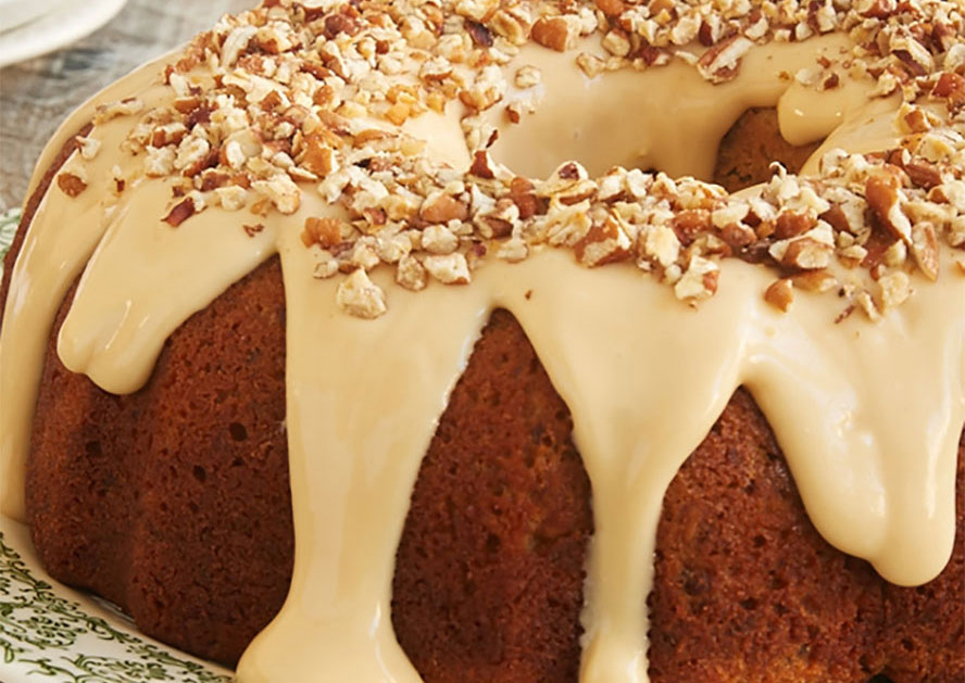 Bundt cake topped with caramel glaze and chopped pecans