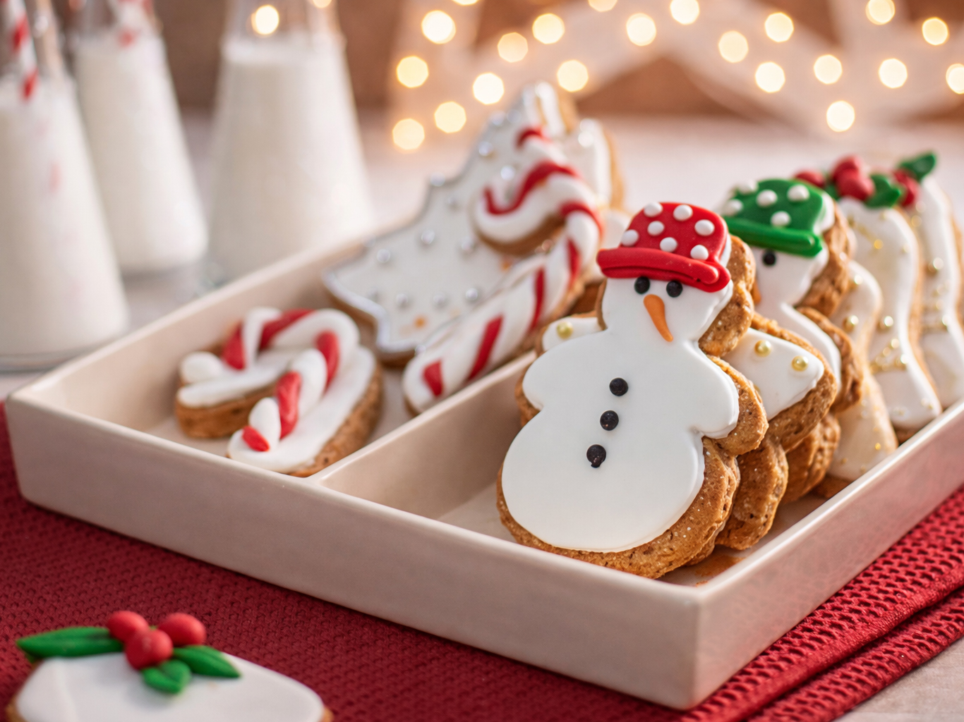 Tray of decorated Christmas cookies, including snowmen, candy canes, and a Christmas tree