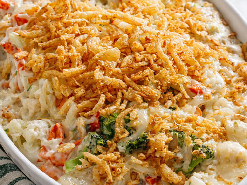 Creamy baked vegetable casserole topped with crispy fried onions