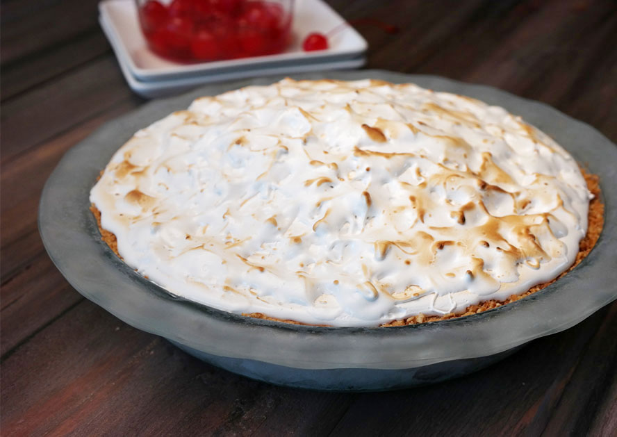 Baked meringue-topped pie in a glass dish