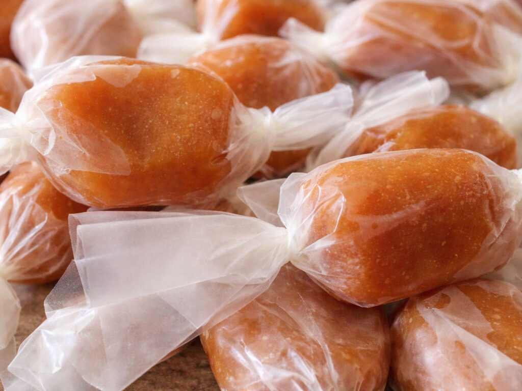Wrapped caramel candies piled together