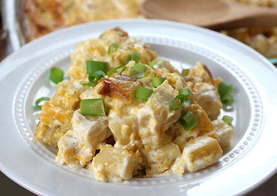 Plate of creamy potato salad topped with chopped green onions