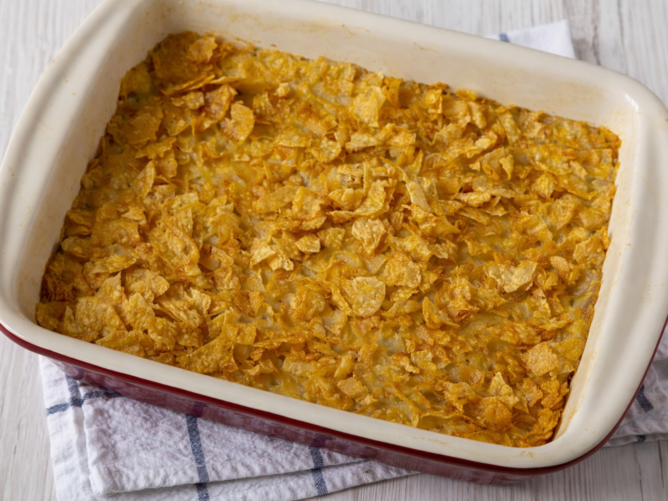 Baked casserole topped with crushed cornflakes in a rectangular dish