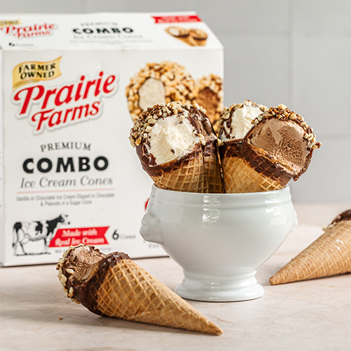 Prairie Farms Premium Combo Ice Cream Cones with vanilla and chocolate frozen desserts dipped in chocolate and chopped nuts, displayed in a white bowl with the product box in the background