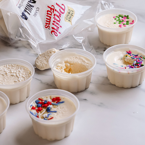 Prairie Farms Vanilla Cups frozen dairy desserts in individual serving cups with colorful sprinkles and the bag they came from in the upper left