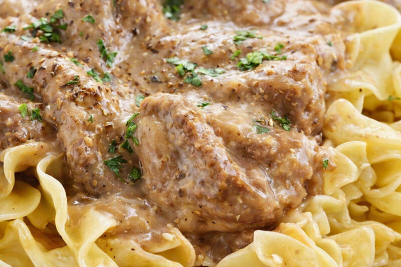 Beef stroganoff over egg noodles, topped with parsley