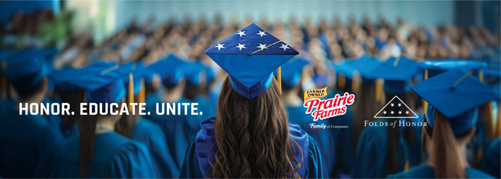 A graduate seen from behind wears a blue cap decorated with white stars while standing among rows of graduates in matching blue gowns at a commencement ceremony. Text over the image reads "Honor Educate Unite" with the Prairie Farms and Folds of Honor logos