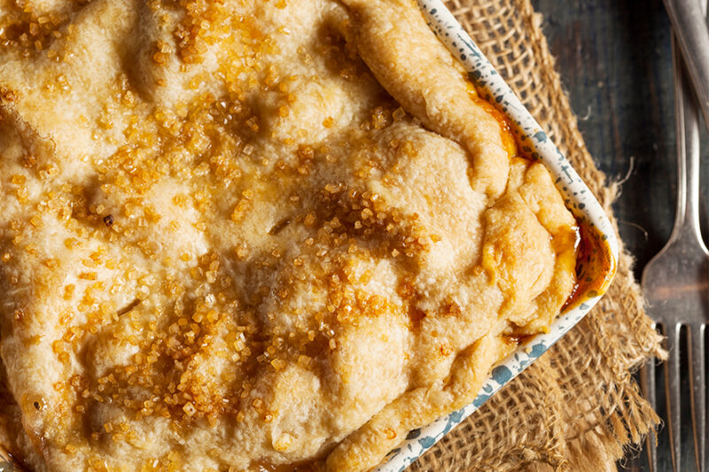 Baked cobbler in a square dish with a golden, sugar-topped crust
